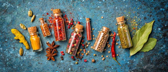 Different spices in glass vials for tasty meals
