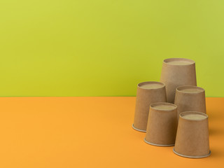 Paper tableware in the orange and light green background.