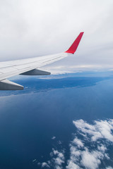 Fototapeta premium Empty airplane wing view via passenger window with blue sky, clean and modern look