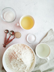 Ingredients for making vegan yeast dough on a light background top view. Recipes step by step.