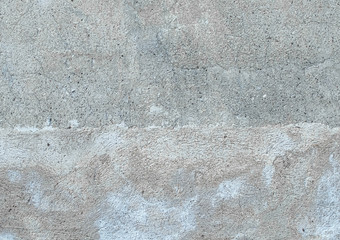 grey concrete wall with many asperities and splinters