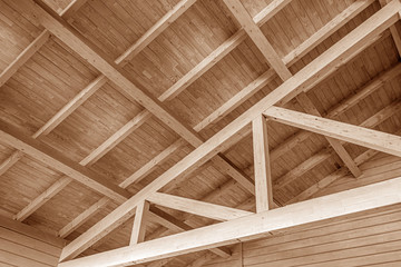 The construction of the wooden roof. Detailed photo of a wooden roof overlap construction.