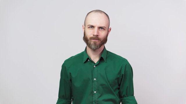 Man showing refusal, shaking his head. Serious bearded man facial expression over white background, no concept.