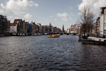 Fototapeta na wymiar panoramic view of the amstel river in the city of Amsterdan with blue cloud sky