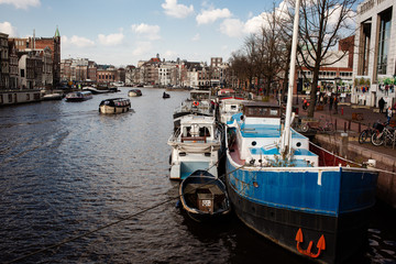 boats on the banks of the canal in the city of amsterdam
