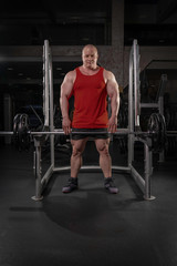 Fototapeta na wymiar muscular man came to the gym and get ready to train