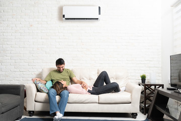 Smiling Latin Couple Relaxing At Home