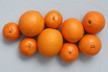 oranges and tangerines on grey background