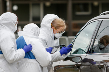 Medics with protective costumes testing for Coronavirus. Covid-19 novel outbreak