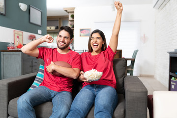 Couple Is Watching Football Match At Home