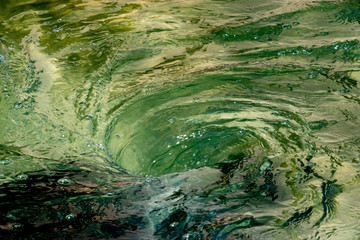 A whirlpool of dark green water