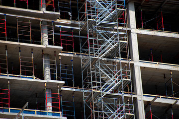 Open faced concrete construction with metal scaffolding stairs 