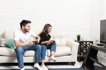 Happy Couple Is Playing Video Game At Home