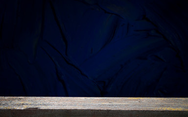 Obraz premium Empty, free, wooden table in front of an abstract dark wall background. Can be used to display or edit your products.