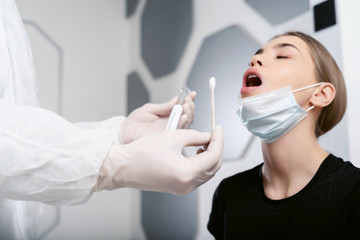 Doctor epidemiologist virologist takes a sample of biological material for analysis on coronavirus....