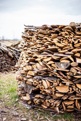 Chopped dry firewood prepared for winter lie exactly stacked one on one on the street. Background of logs, birch, pine and oak..
