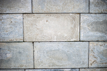 Fototapeta premium Old gray brick wall. Brickwork with uneven seams.