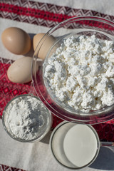 Fresh homemade cottage cheese, milk and eggs. Ingredients for cottage cheese pancakes with oats. Dairy products. Healthy breakfast.