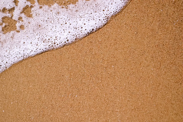 texture of sand and sea foam on the black sea beach, copy space