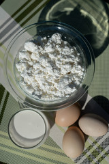 Fresh homemade cottage cheese, milk and eggs. Ingredients for cottage cheese pancakes with oats. Dairy products. Healthy breakfast.