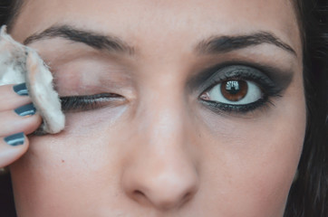 close up on white woman face removing makeup