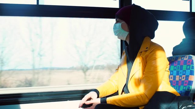 Volunteer in a medical mask in a public transport bus. Preventive measures to protect people. Quarantine, the coronavirus infection COVID-19 pandemic in Europe. 