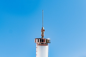 An old glass syringe with a needle