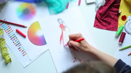 Fashion designer draws a sketch of women's clothing.
