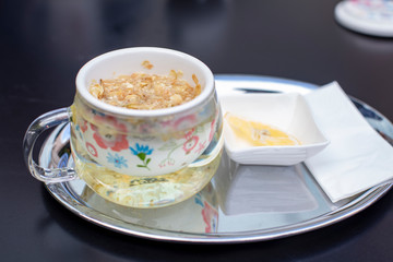 A cup of jasmine tea with lemon and honey