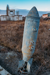 Unexploded bomb in the grass, war and peace concept