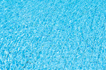 Fototapeta na wymiar Water in swimming pool rippled water detail background.
