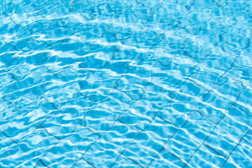 Water in swimming pool rippled water detail background.