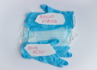 medical mask and gloves on a light background.  pandemic.  coronavirus.  2019-nCoV.  flat layout
