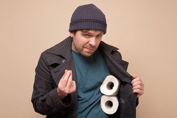 huckster man holding several roll of toilet paper. Do you want to buy it