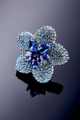 Plastic jewelry earrings with crystals and stones for women on a dark background.