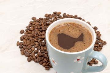 Cup Of Black Coffee With Coffee Beans On The White Table