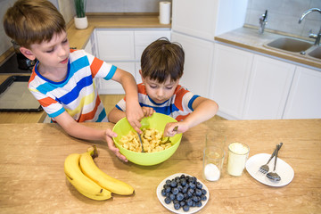 happy family funny kids are preparing the dough, bake cookies in the kitchen