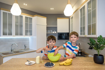 Fototapeta premium happy family funny kids are preparing the dough, bake cookies in the kitchen