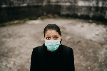 Patient suffering from infectious disease,sick person in mask.Scared woman suffering from symptoms...