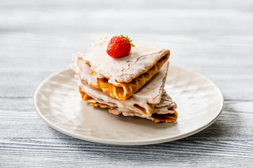 Waffles and strawberries on a grey wooden background. Dessert with berries