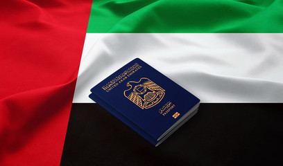 Passport of United Arab Emirates on the top of an  flag of emirates 