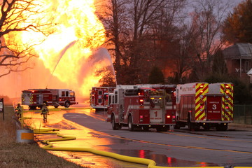 Multiple fire engines are use to attempt to control a major gas line rupture and fire.