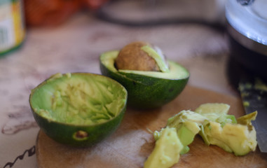 Two half avocado on a cutting board in the kitchen