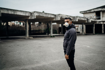 Scared worried man wearing a protective mask.Activities in time of epidemic/pandemic.Panic and fear of infection.Life in contaminated area.Actions for prevention and control.Nosophobia