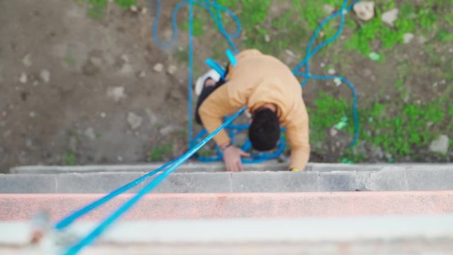 Descent safety rope. Movie Stuntman performs extreme descent in urban conditions. Staging stunts for the cinema
