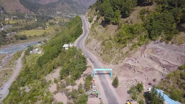 Aerial view of Bus going on mountains road in Pakistan Balakot Naran valley KPK having river on one side