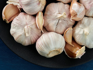 Ripe garlic lies on a wooden blue background.Healthy food.Spices