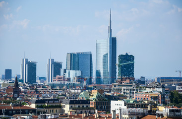 Milan cityscape at summer day with new modern skyscrapers of Porta Nuova business district from Duomo roof terrace in Italy