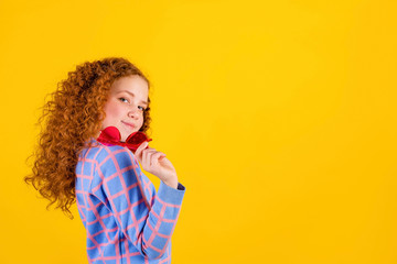 red haired , emotional girl with red glasses on a yellow background