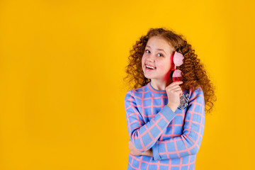 red haired , emotional girl with red glasses on a yellow background